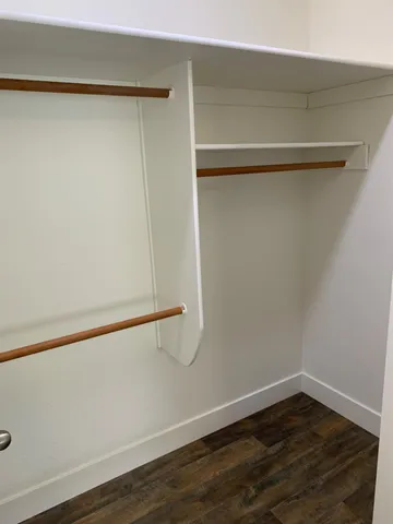 a view of a room with wooden floor