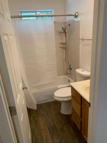 a bathroom with a toilet and a shower