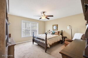 338 Pistole Road Sparta, TN 38583 - Photo 16 of 39 a bedroom with a bed and a chandelier