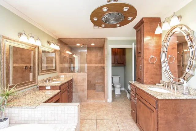a bathroom with a sink a large mirror and a shower