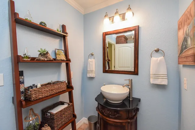 a bathroom with a sink toilet and mirror