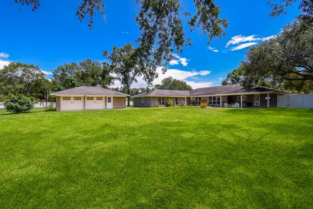a house view with a sitting space and garden
