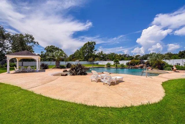 a front view of a house with garden and lake view