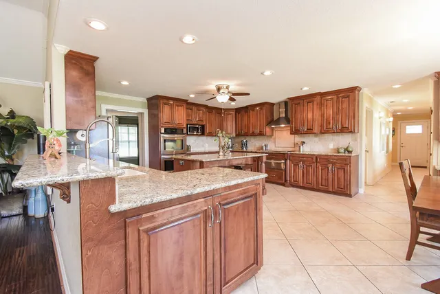 a kitchen with stainless steel appliances kitchen island granite countertop a sink and cabinets