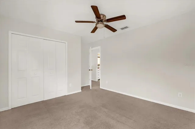 a view of a livingroom with a ceiling fan and a window