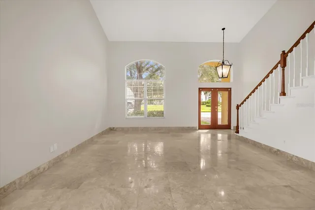 a view of an empty room with windows