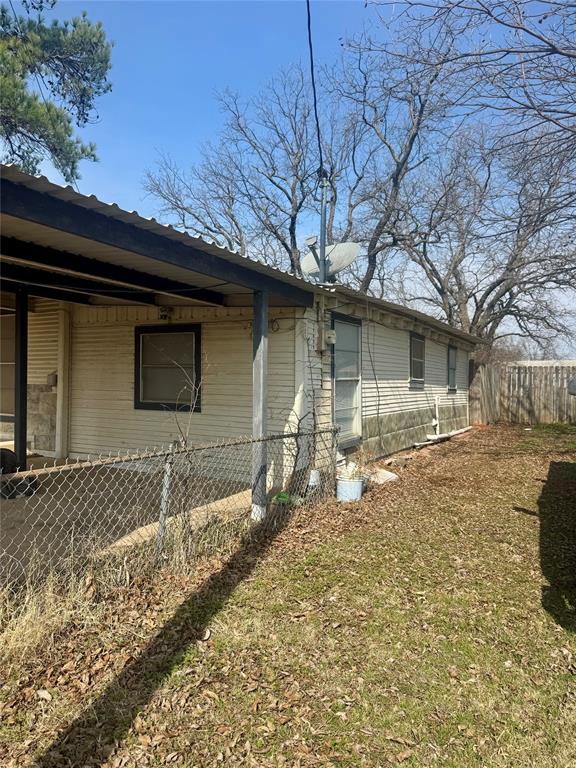 316 West Alley Street Perrin, TX 76486 - Photo 3 of 18 Looking down the side of the carport to the back of the home.