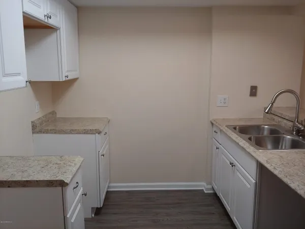 a kitchen with a sink and cabinets