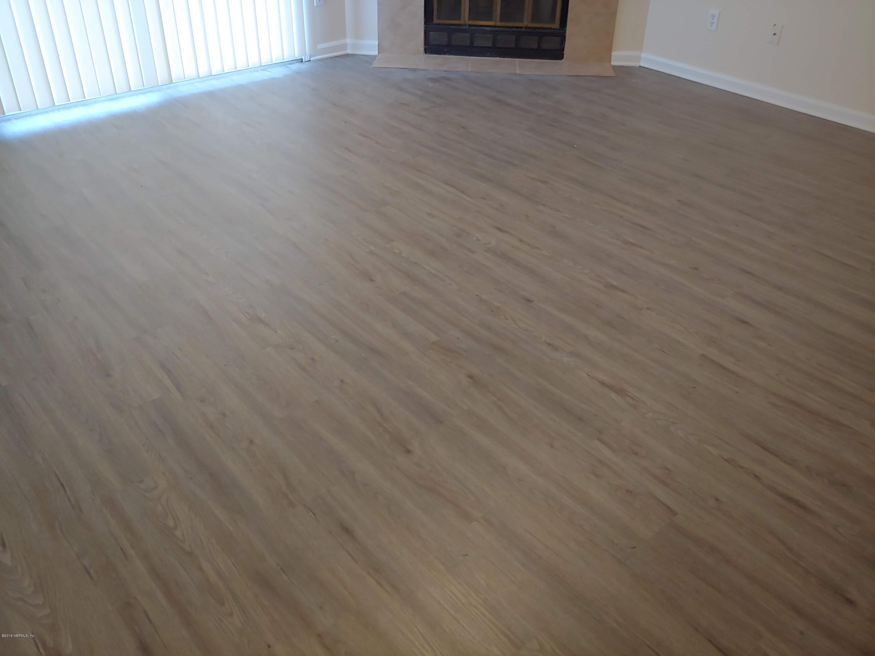 791 Assisi Lane, Unit 303 Jacksonville, FL 32233 - Photo 16 of 35 a view of a livingroom with wooden floor