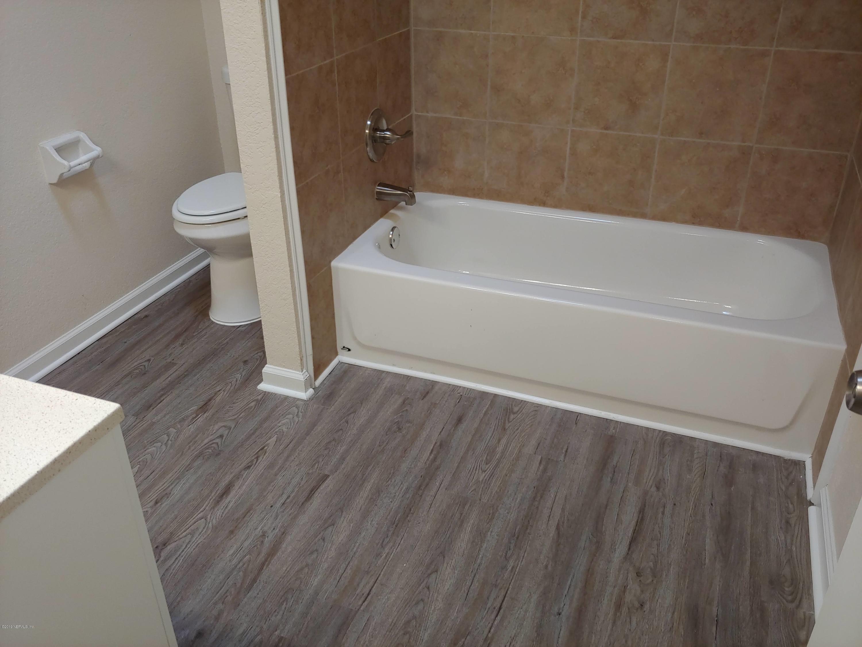 791 Assisi Lane, Unit 303 Jacksonville, FL 32233 - Photo 20 of 35 a bathroom with a sink and a toilet