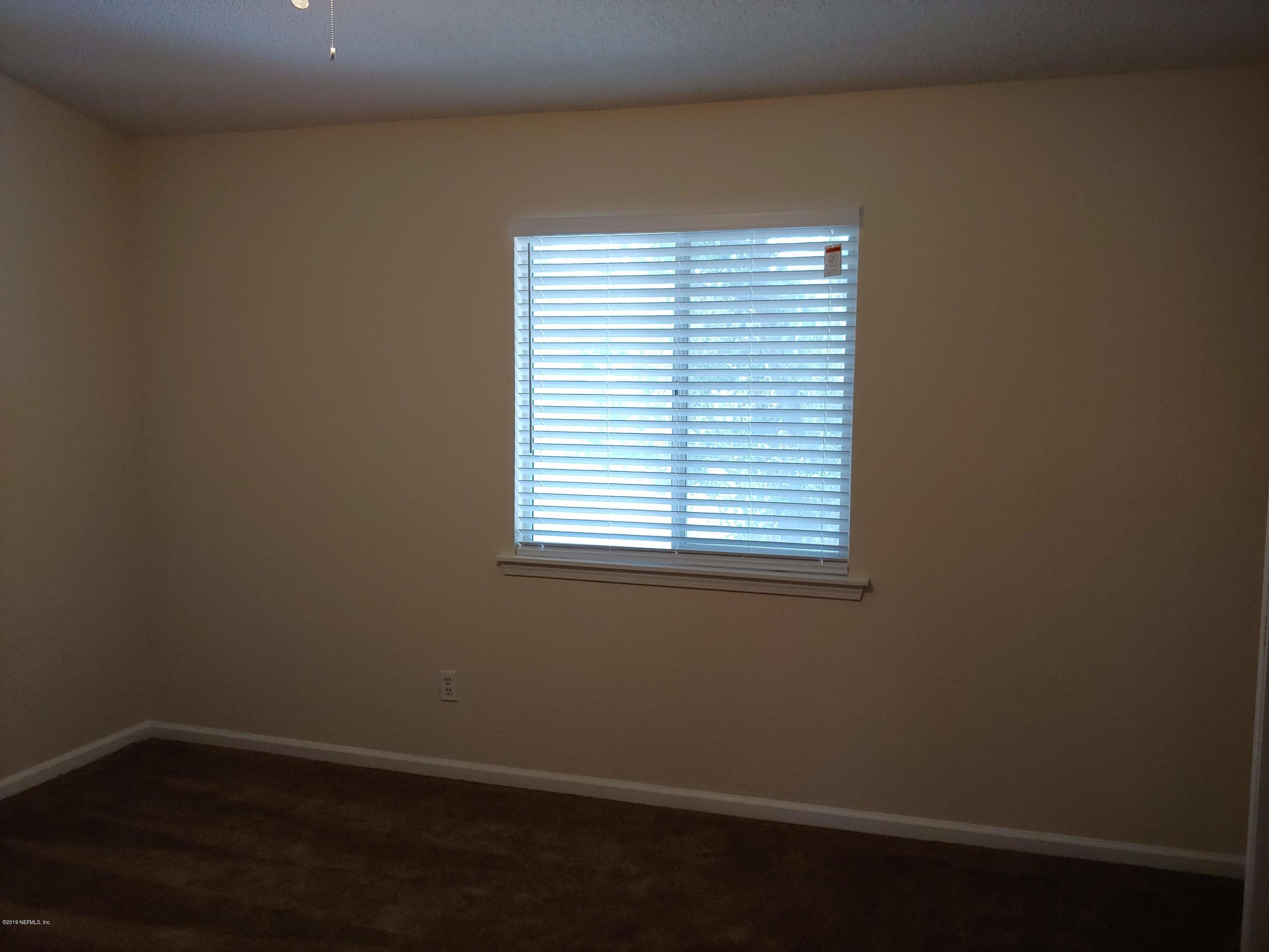 791 Assisi Lane, Unit 303 Jacksonville, FL 32233 - Photo 29 of 35 a view of a small space with wooden floor and a window