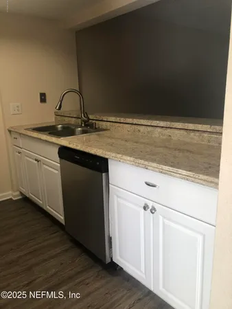 an empty room with wooden floor and a fireplace