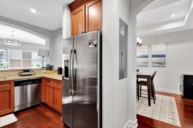 a kitchen with stainless steel appliances granite countertop a refrigerator and a stove top oven