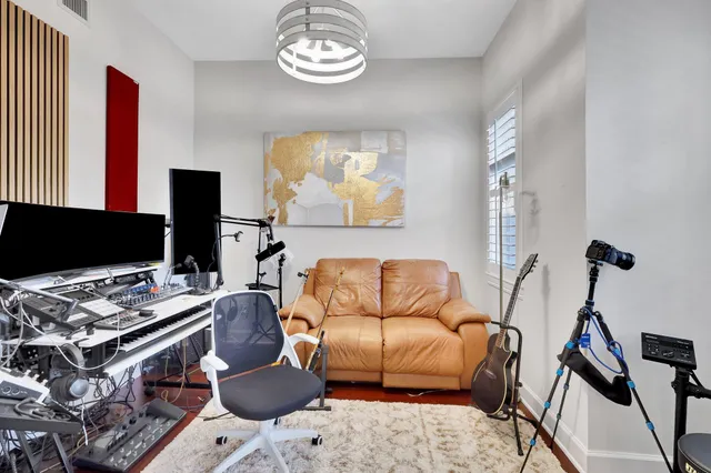 a living room with furniture a rug and a flat screen tv