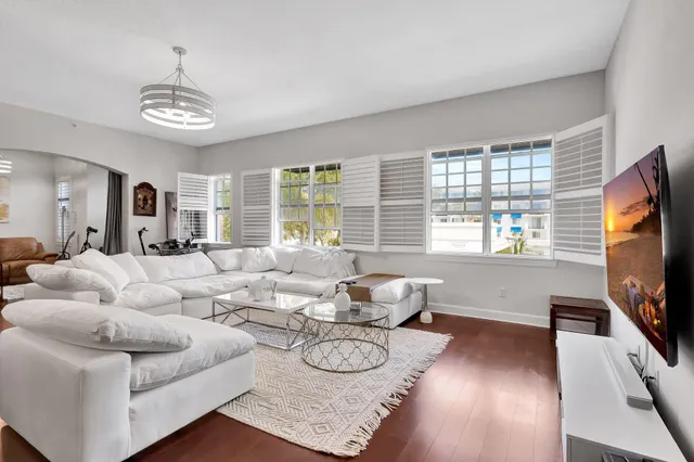 a living room with furniture a window and a flat screen tv