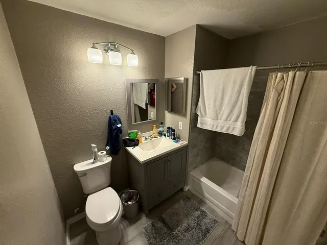 a bathroom with a sink toilet and tub