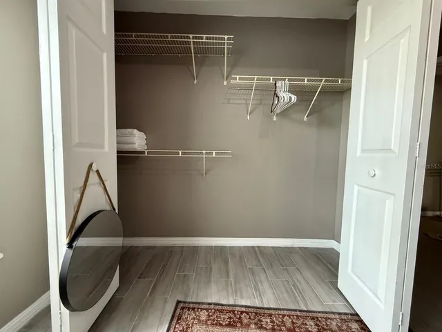 a view of a room with wooden floor and bathroom