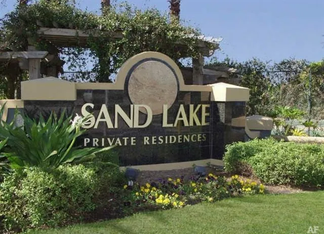 a sign that is sitting in front of flowers