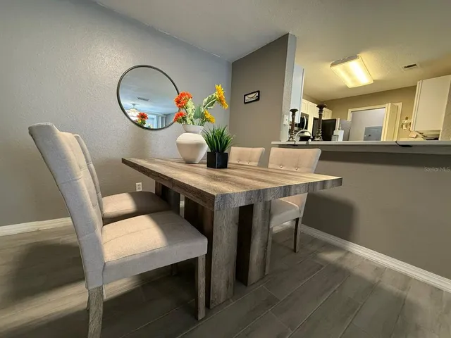 a view of a dining room with furniture and wooden floor