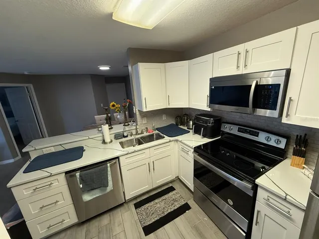 a kitchen with a stove and a microwave