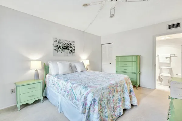 a bedroom with a large bed and a cabinets