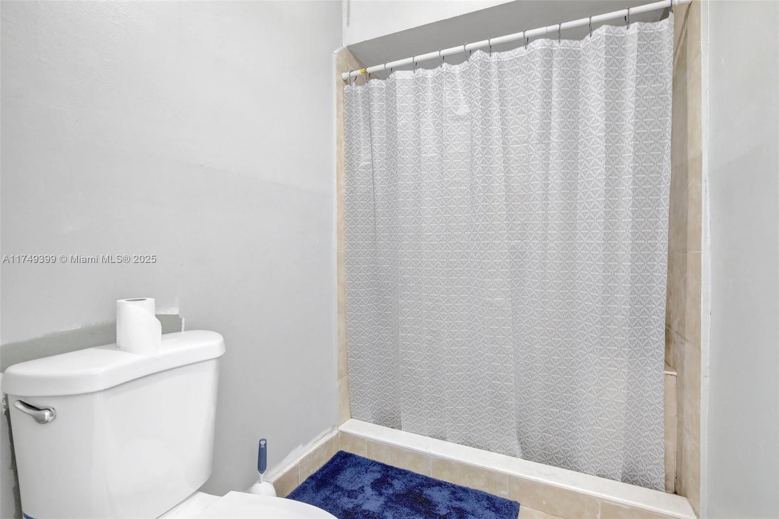 1945 West 72nd Street Hialeah, FL 33014 - Photo 12 of 24 a bathroom with a shower curtain and sink