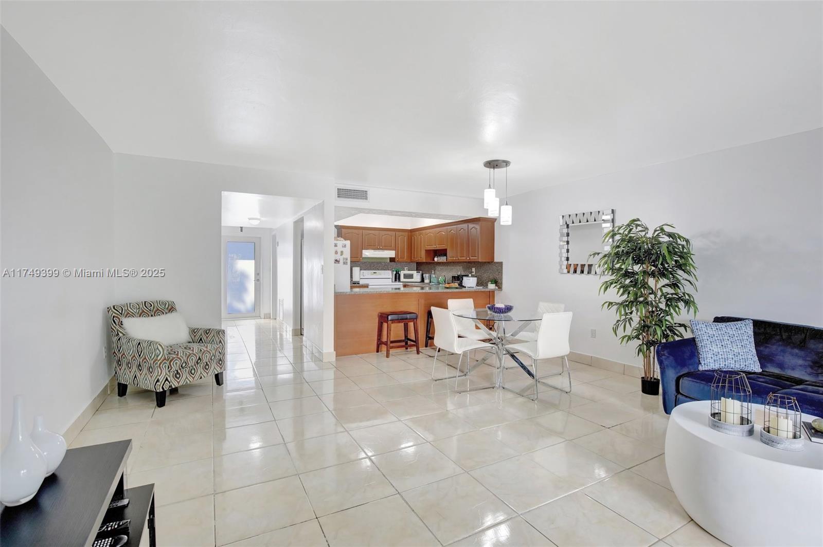 1945 West 72nd Street Hialeah, FL 33014 - Photo 8 of 24 a living room with furniture and a table
