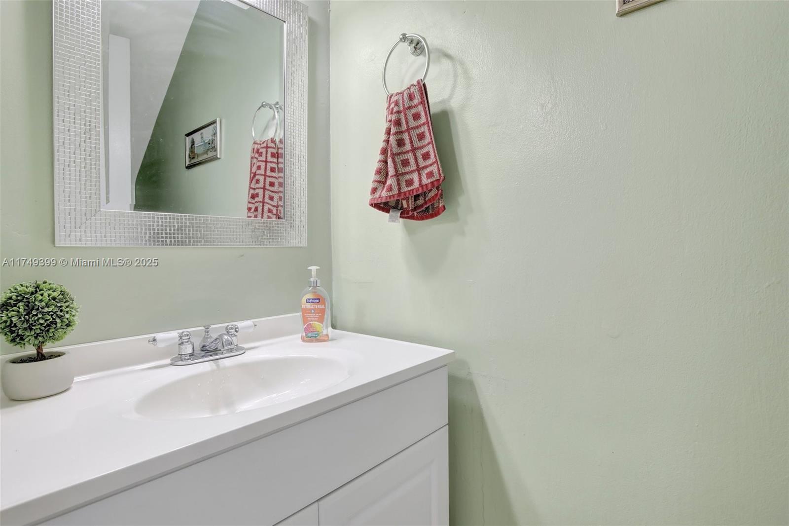 1945 West 72nd Street Hialeah, FL 33014 - Photo 9 of 24 a bathroom with a sink and a mirror