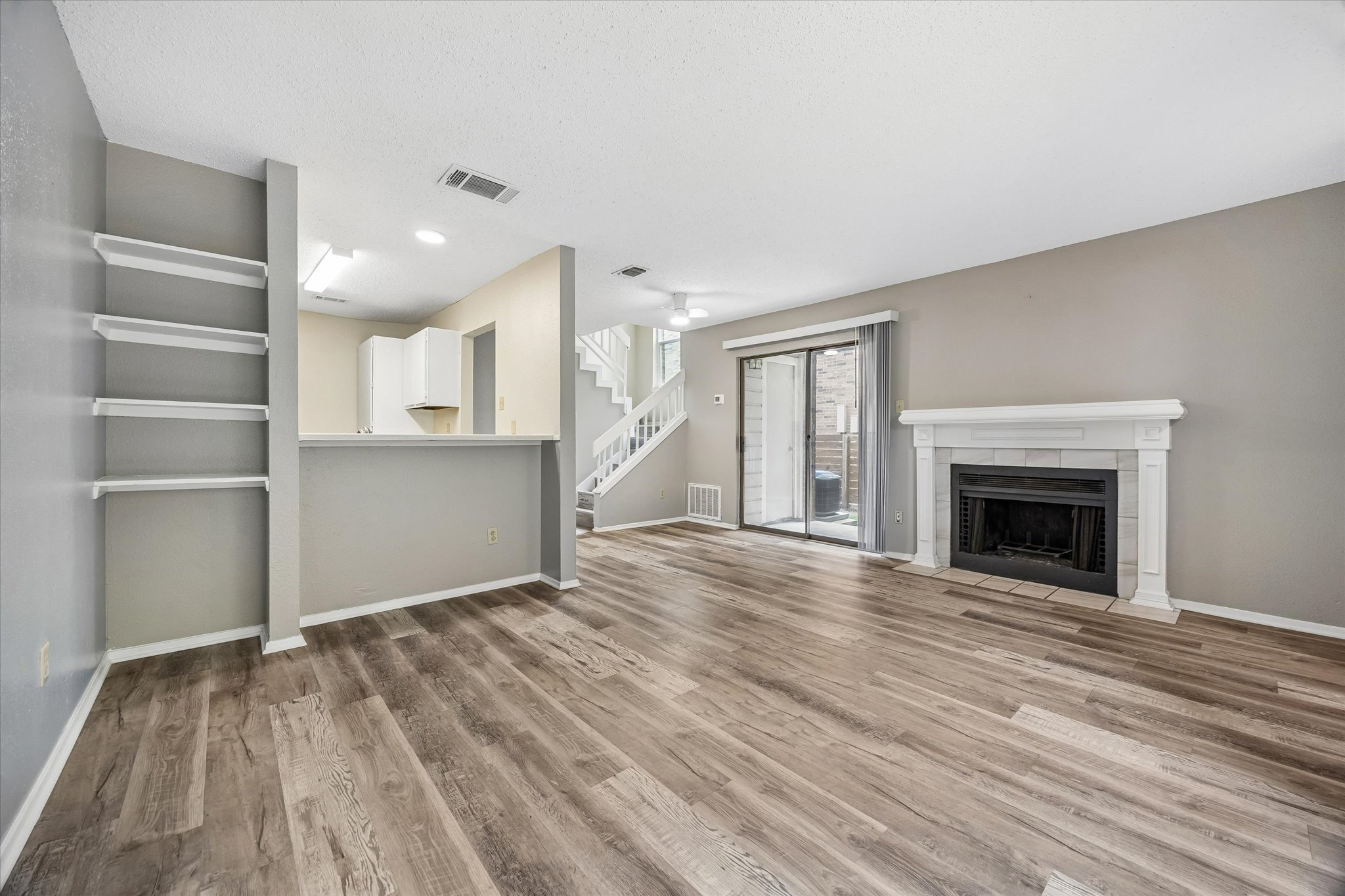 2018 West Rundberg Lane, Unit 13A Austin, TX 78758 - Photo 4 of 11 a view of an empty room with a fireplace and a window