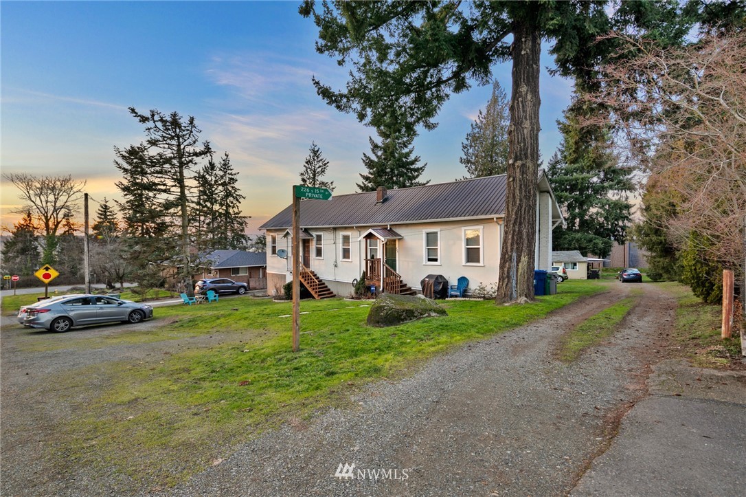 222 South 15th Street Renton, WA 98055 - Photo 1 of 34 a view of a white house next to a yard and a road