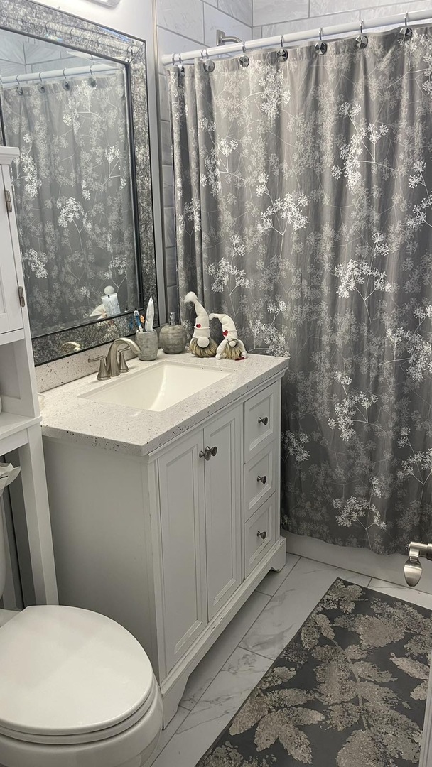 2749 Virginia Lane Glenview, IL 60025 - Photo 15 of 39 a bathroom with a sink a toilet and shower