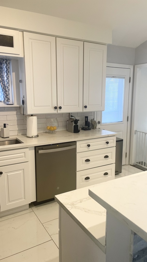2749 Virginia Lane Glenview, IL 60025 - Photo 20 of 39 a kitchen with granite countertop cabinets and white appliances