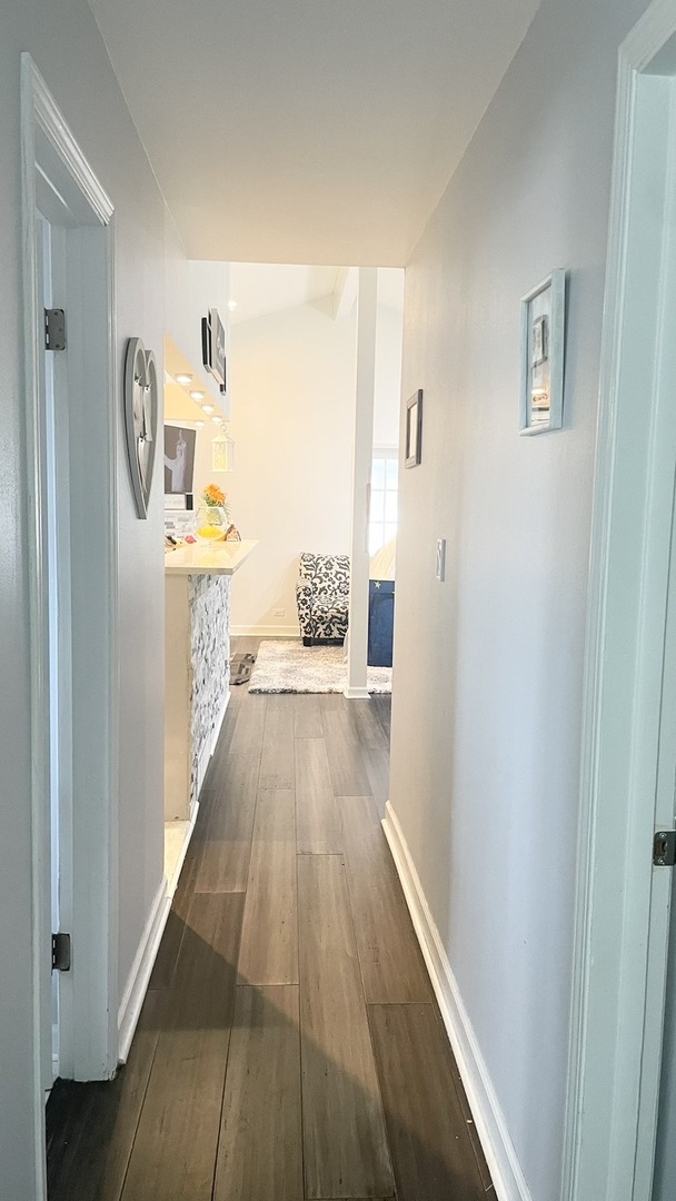 2749 Virginia Lane Glenview, IL 60025 - Photo 5 of 39 a view of a hallway with wooden floor and a bathroom