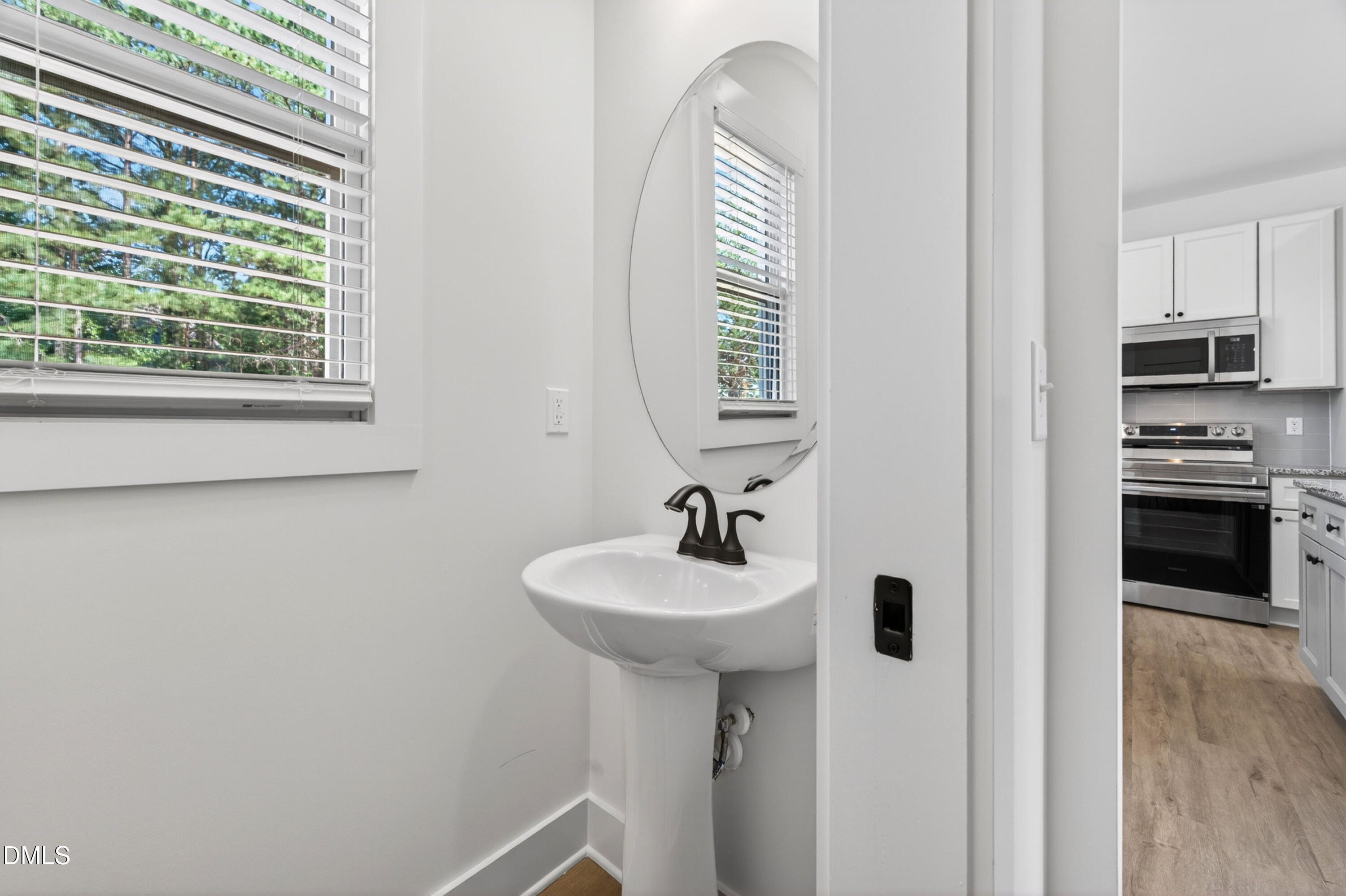 1196 Hurdle Mills Road Roxboro, NC 27573 - Photo 22 of 50 a bathroom with a sink a mirror and a window