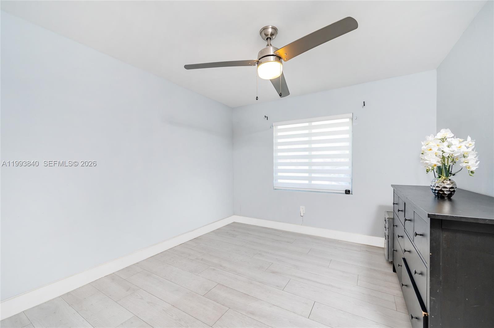 1820 Southwest 140th Place Miami, FL 33175 - Photo 12 of 22 a view of a room with a large window and chandelier fan