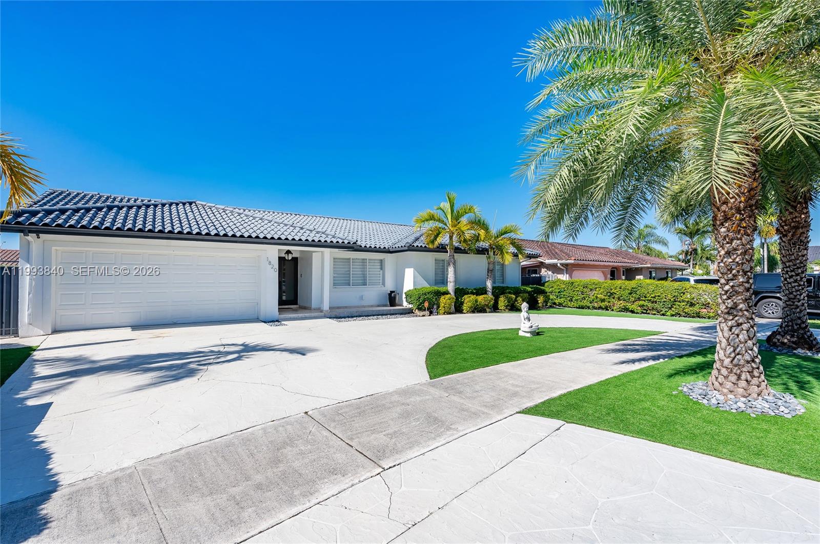 1820 Southwest 140th Place Miami, FL 33175 - Photo 4 of 22 a front view of a house with a yard and garage