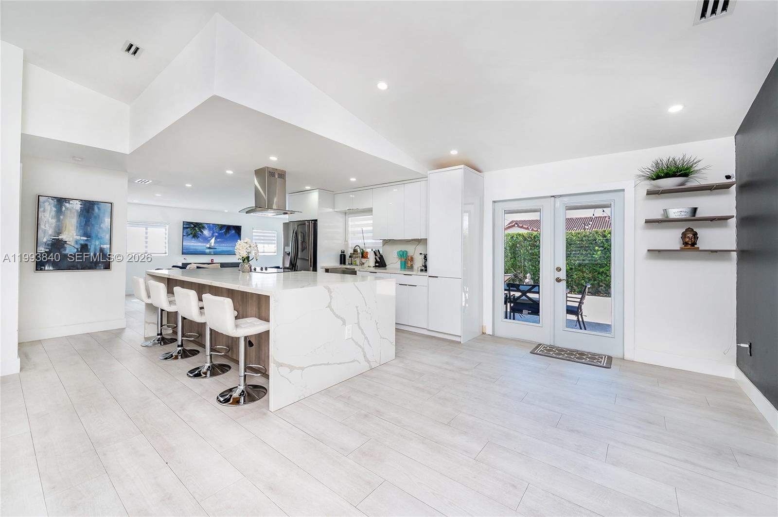 1820 Southwest 140th Place Miami, FL 33175 - Photo 9 of 22 a view of kitchen with kitchen island a island a stove a refrigerator cabinets a dining table and chairs
