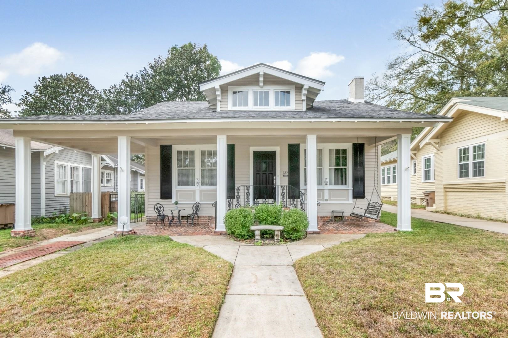 135 Silverwood Street Mobile, AL 36607 - Photo 1 of 32 Bungalow-style home with a front lawn, a porch, roof with shingles, and a chimney