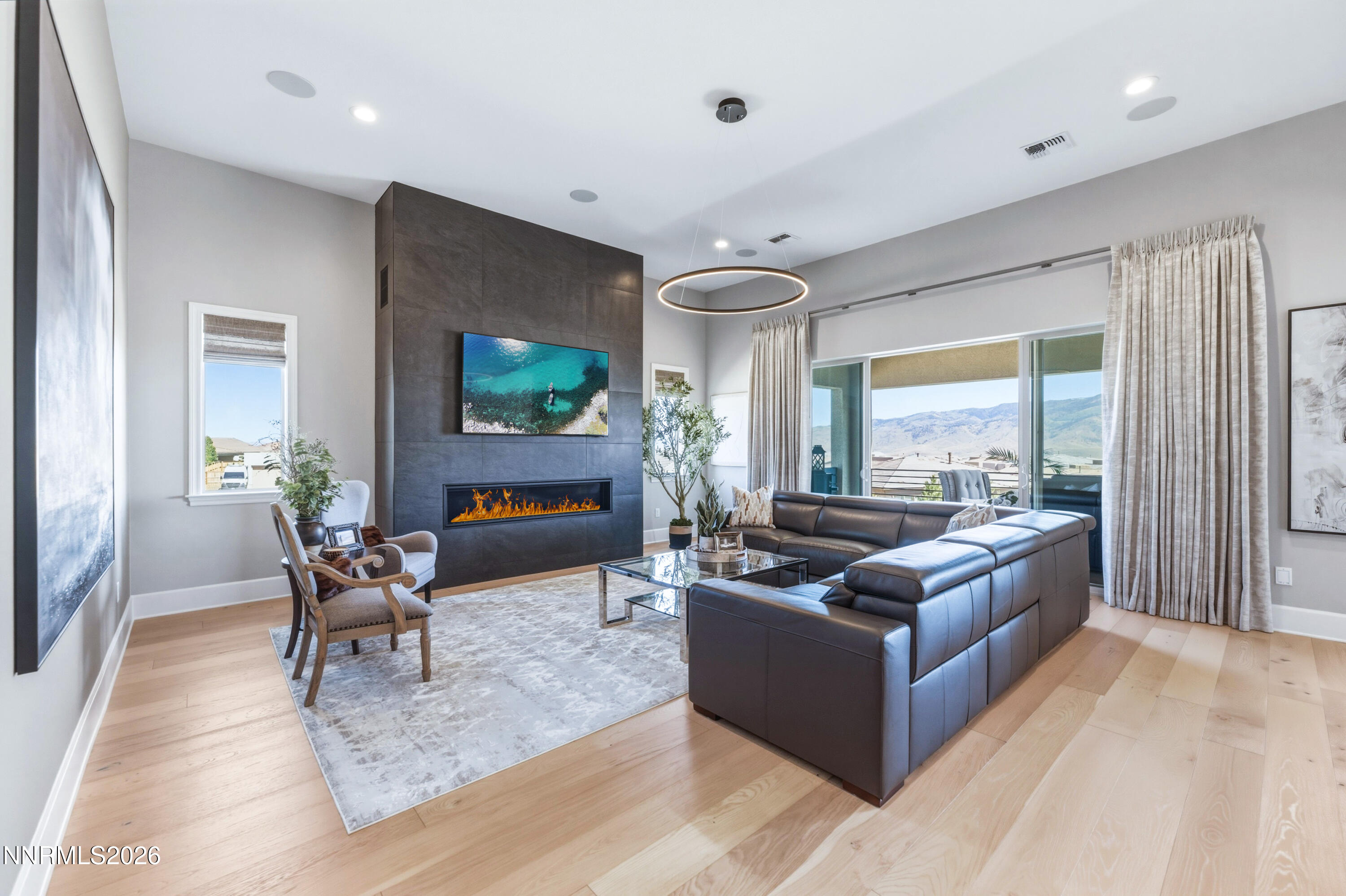 9028 Iron Sky Court Reno, NV 89523 - Photo 5 of 36 a living room with furniture and a fireplace