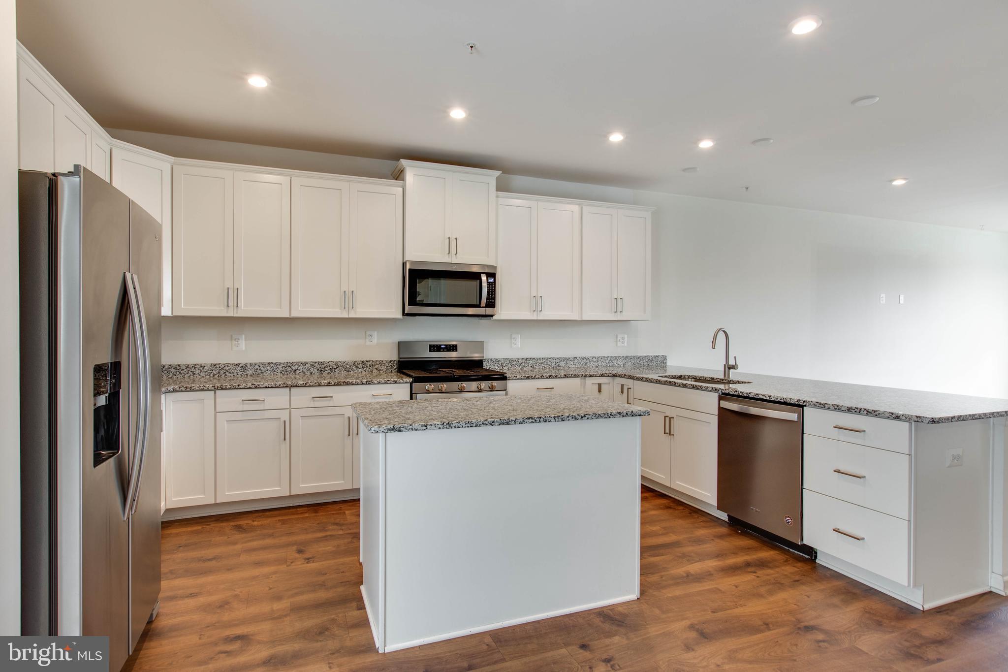 1922 Red Jasper Road Hanover, MD 21076 - Photo 15 of 49 a kitchen with kitchen island granite countertop white cabinets and stainless steel appliances