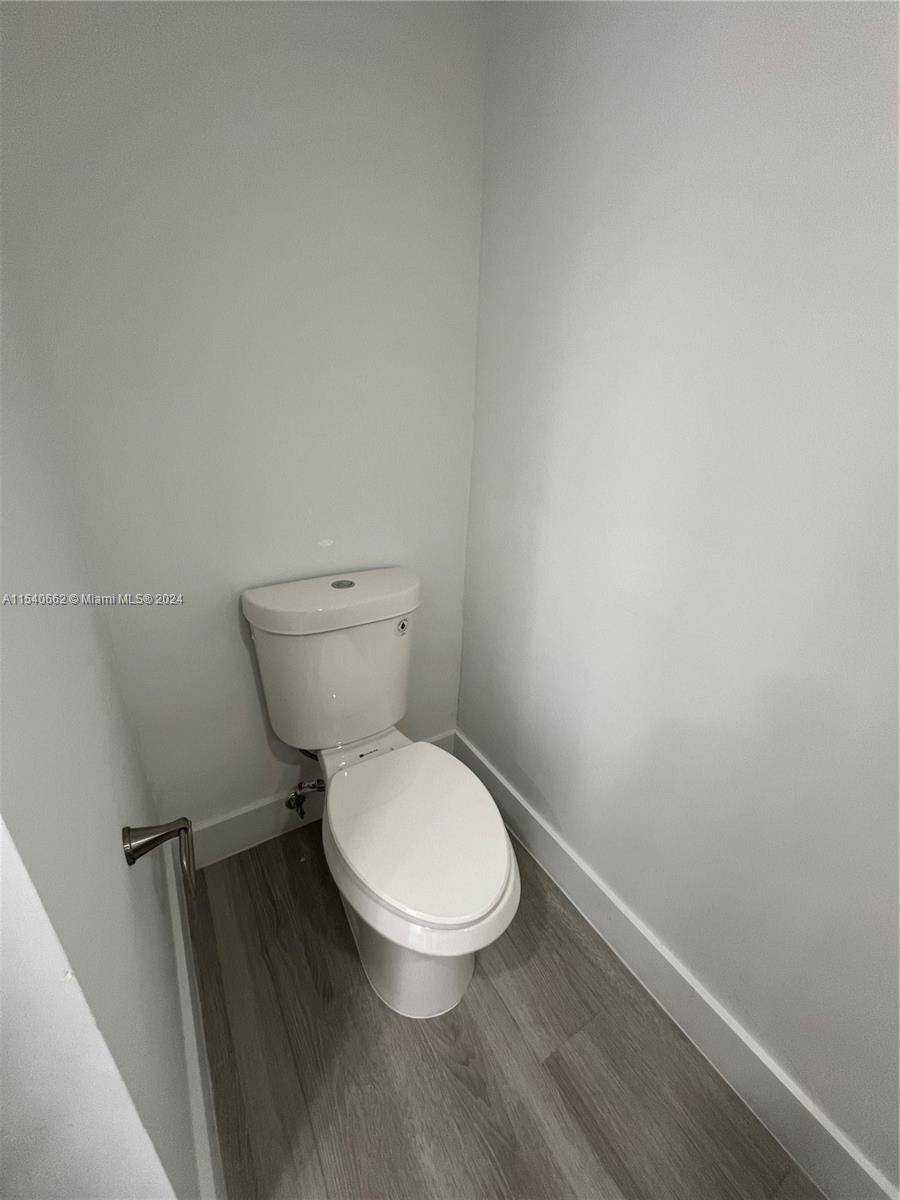 14155 Southwest 87th Street, Unit E108 Miami, FL 33183 - Photo 8 of 9 a white toilet sitting next to a sink