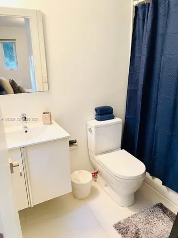 a bathroom with a sink toilet and mirror
