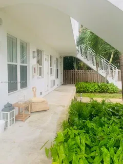 a view of house with backyard and outdoor seating