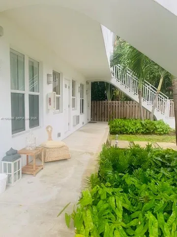 a view of house with backyard and outdoor seating