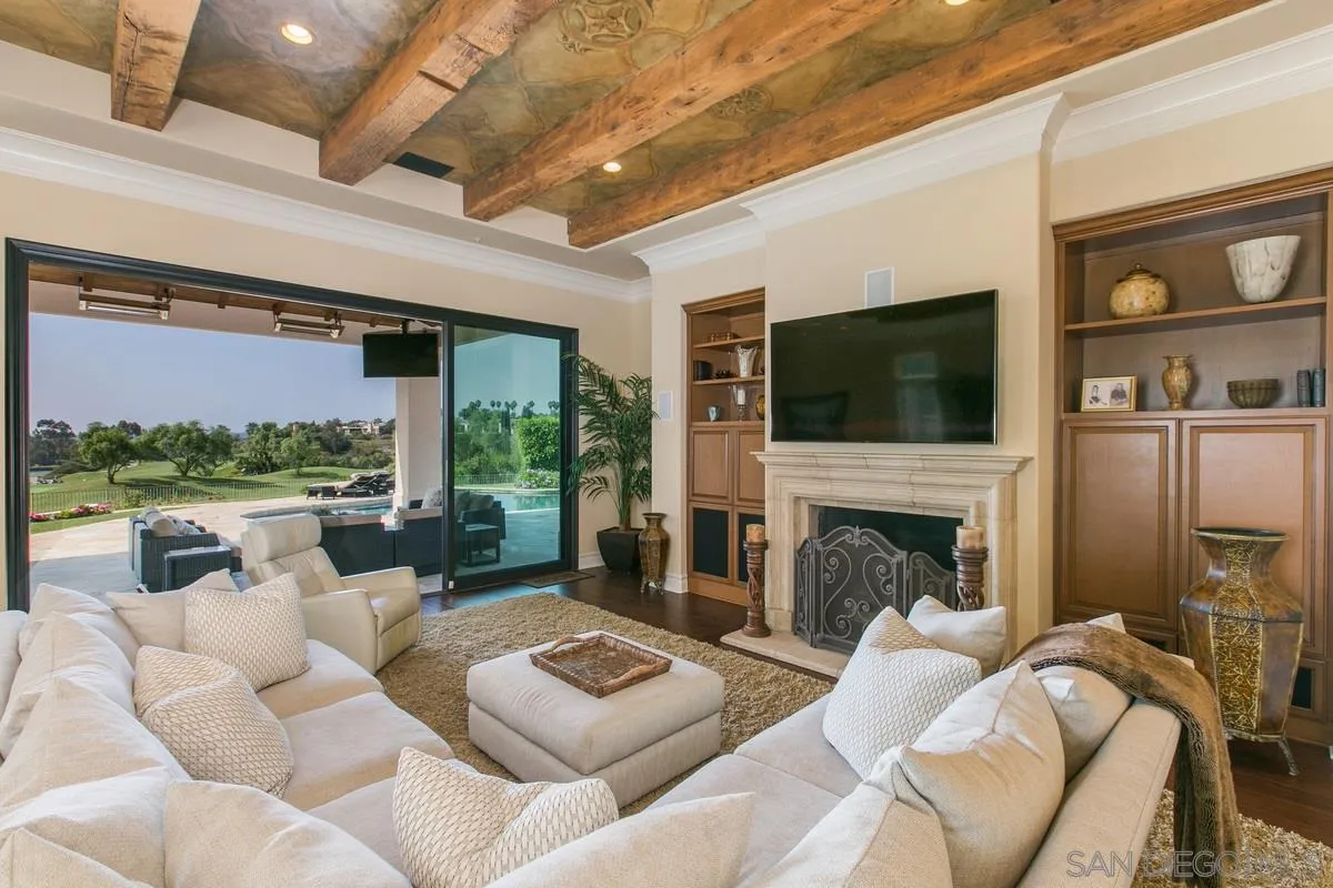 7330 St Andrews Road Rancho Santa Fe, CA 92067 - Photo 11 of 28 a living room with furniture fireplace and a flat screen tv