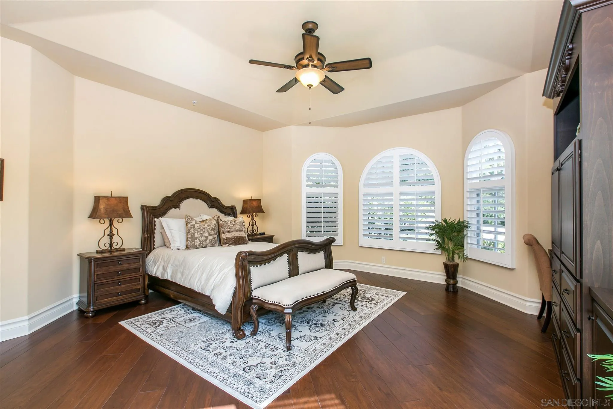 7330 St Andrews Road Rancho Santa Fe, CA 92067 - Photo 21 of 28 a spacious bedroom with a bed a chandelier and a rug