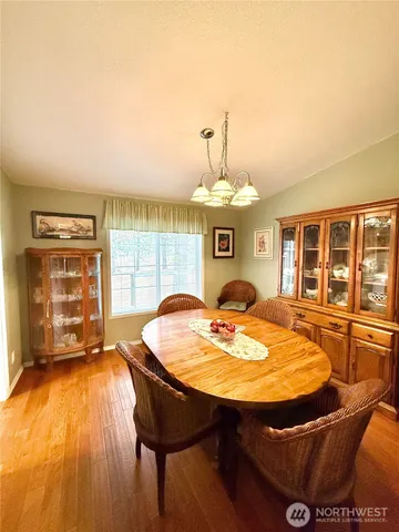 a dining room with a table and chairs