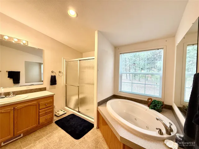 a bathroom with a bathtub sink and mirror