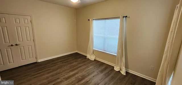 an empty room with wooden floor
