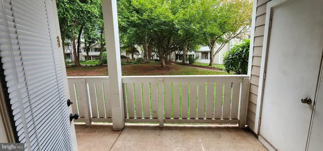a view of a door and wooden fence